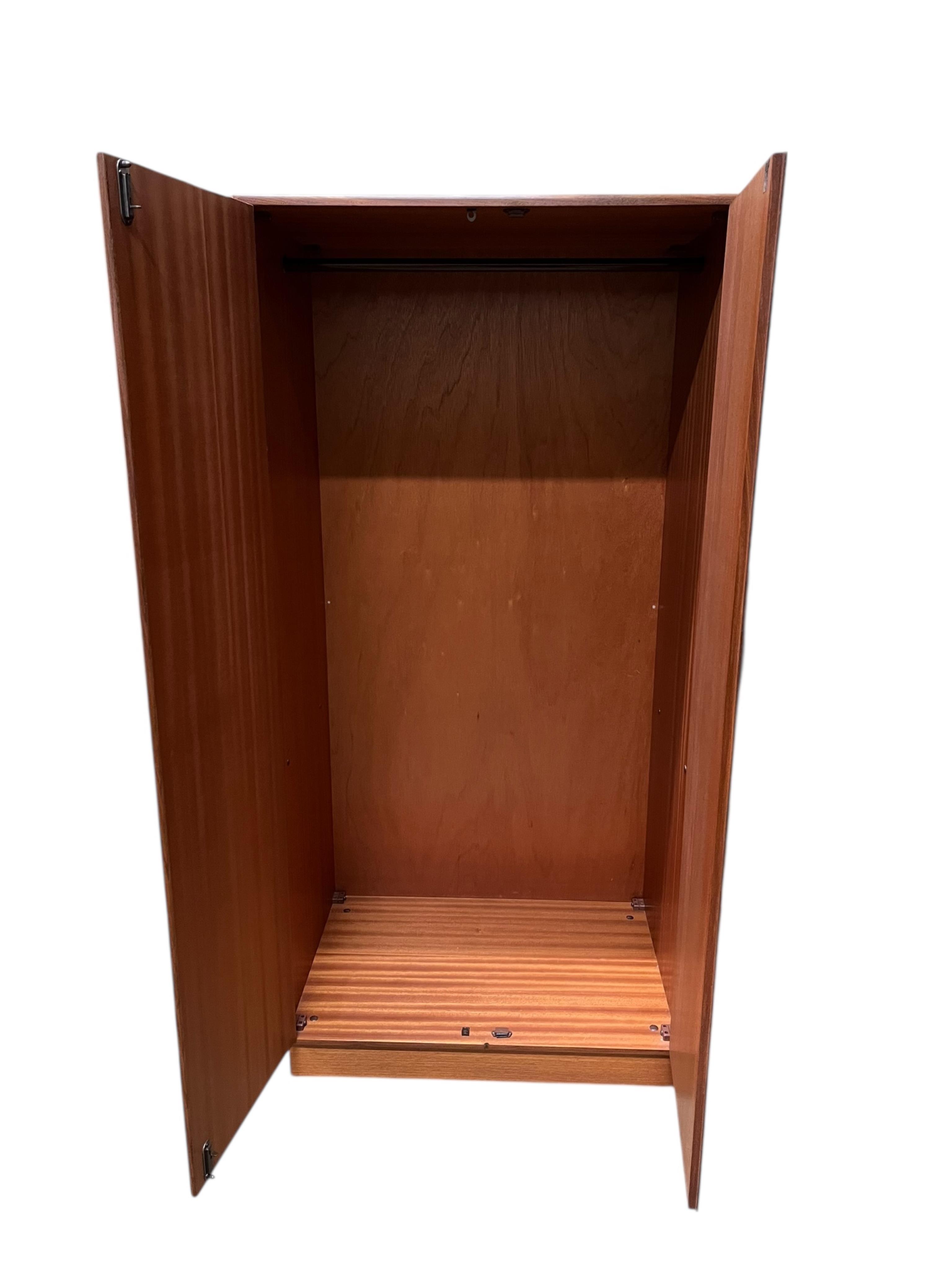 A mid century G Plan Fresco teak bedroom suite comprising a three door wardrobe, a two door wardrobe, two six drawer chests, dressing table, headboard and a pair of bedside chests